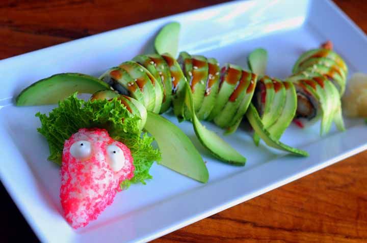 Dragon roll shaped like a dragon, topped with avocado
