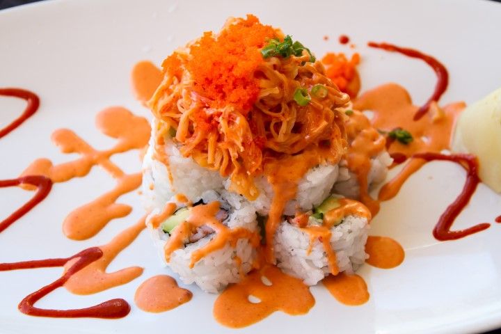 Volcano roll piled with baked spicy scallops and masago