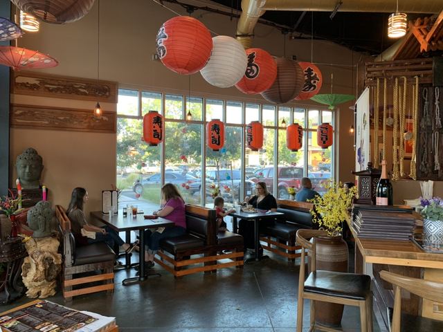 Guests at window-side tables with red and white paper lanterns