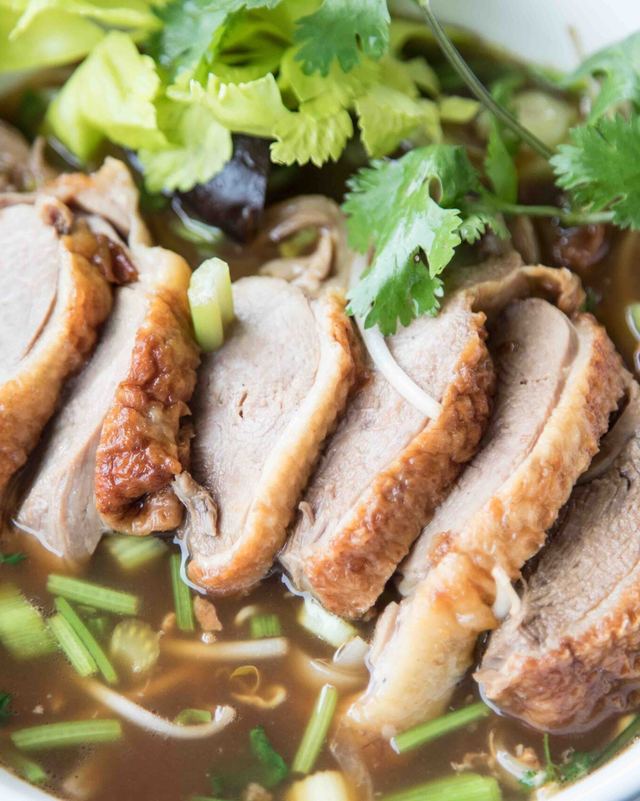 Duck noodle soup with sliced roast duck and cilantro