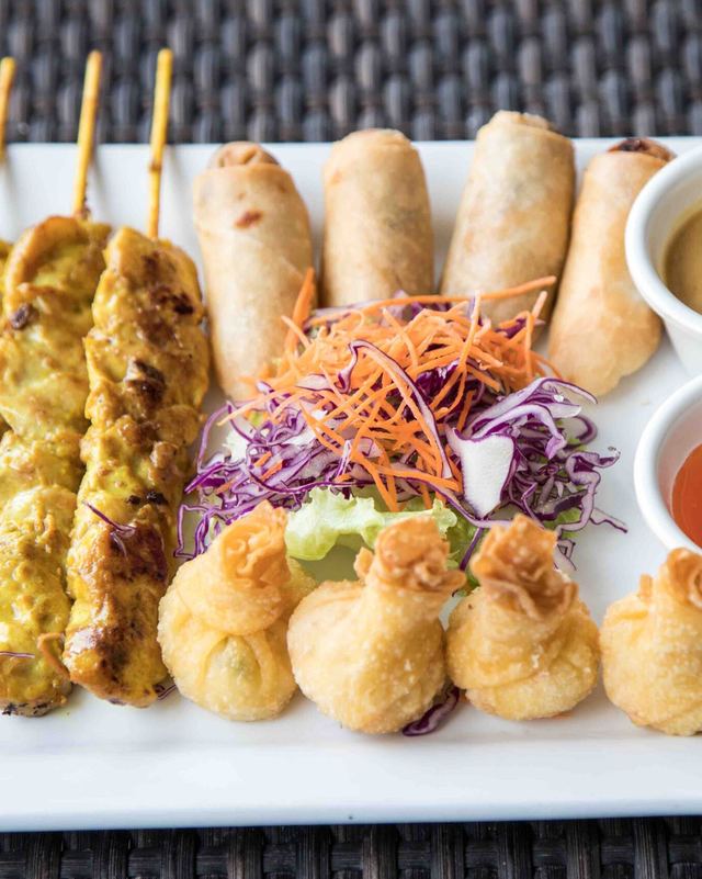 Thai Thani Sampler platter of satay skewers, krab rangoon and egg rolls